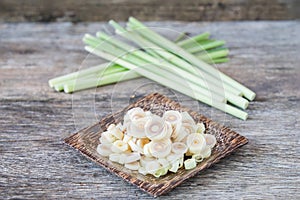 Fresh lemongrass slices on wooden background - Spice for health.