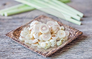 Fresh lemongrass slices on wooden background - Spice for health.