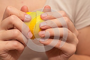 Fresh Lemons in Basket Held by Hands. Close-up of fresh yellow lemons in a woven basket held in hands