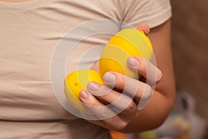 Fresh Lemons in Basket Held by Hands. Close-up of fresh yellow lemons in a woven basket held in hands