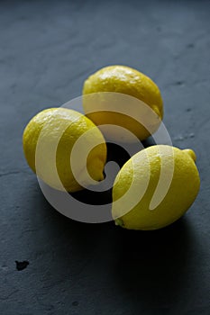 Fresh lemons on black background