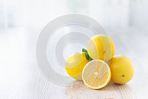 Fresh lemons on bright kitchen table.