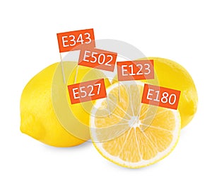 Fresh lemons with E numbers on background. Harmful food additives