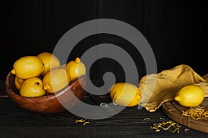 Fresh lemons and lemon zest on the wooden table