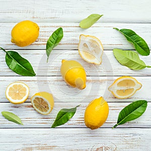 Fresh lemons and lemons leaves on rustic wooden background. Fre