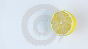 Fresh lemons rotating in a circle, white background, and space for text.