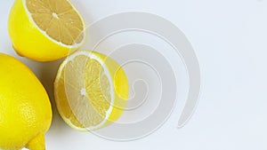 Fresh lemons rotating in a circle, white background, and space for text.