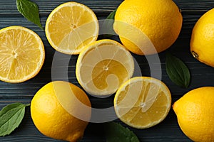 Fresh lemons on wooden background, top view
