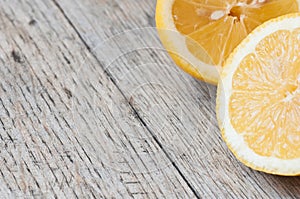 Fresh lemons on a wooden surface with copy space to left