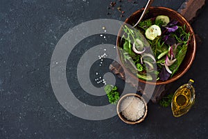 Fresh lettuce, arugula, frisee, basil, cucumber and onions salad