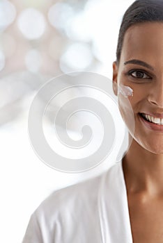 Fresh and light skin care options. Closeup portrait of a gorgeous young woman applying moisturizer to her skin.