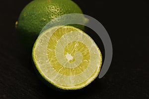 Fresh lime in close up, isolated with black background