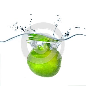 Fresh lime dropped into water