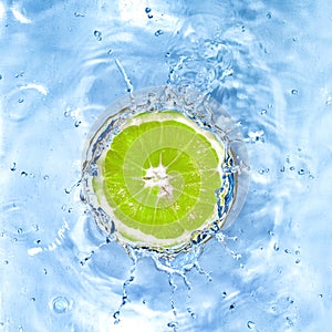 Fresh lime dropped into water