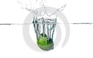 Fresh lime falling into water