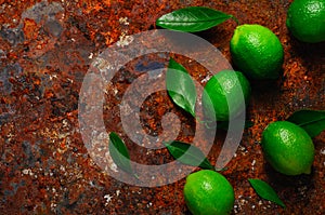 Fresh lime with leaves on rusty metal background