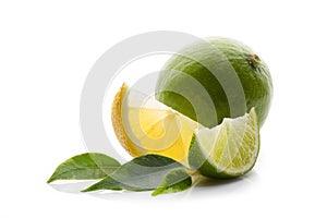 Fresh lime, lemon cut in half and into pieces, with green leaves