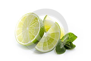 Fresh lime. Slices of ripe and juicy lime with green mint leaves close-up