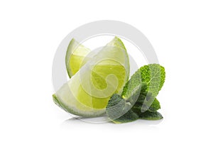 Fresh lime. Slices of ripe and juicy lime with green mint leaves close-up