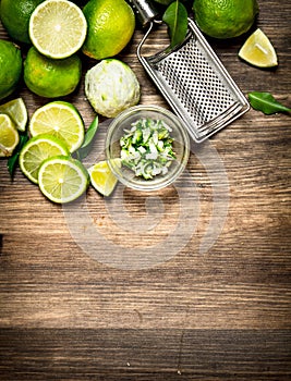 Fresh limes with grater and zest.