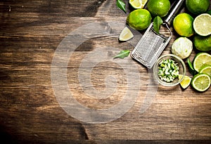 Fresh limes with grater and zest.