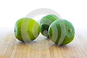 Fresh limes on wooden table