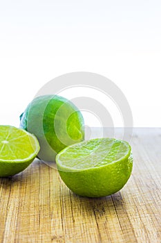 Fresh limes on wooden table