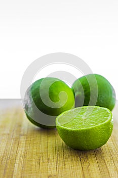 Fresh limes on wooden table