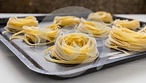 Fresh linguine pasta twirled on sheet pan