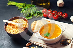 Fresh liquid pea soup on pork broth. bean soup with parsley. healthy breakfast. black concrete background. selective focus.