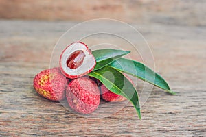 Fresh litchi fruit on an old wooden background photo
