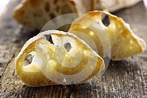 Fresh Loaf of Ciabatta Bread , Sliced on a Wooden Board