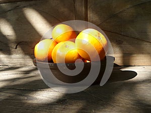 Fresh lucky orange basket on wooden table