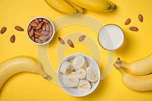 Fresh made banana smoothie in a glass on pink background