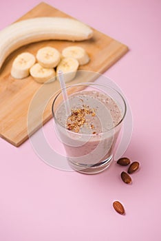 Fresh made Banana smoothie on pink background