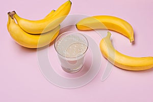 Fresh made Banana smoothie on pink background