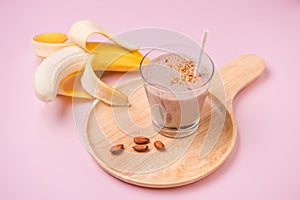 Fresh made Banana smoothie on yellow background