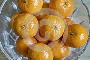 Fresh mandarin oranges also known as Citrus reticulata placed in a crystal bow