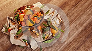 Fresh mandarin oranges fruit or tangerines with leaves in display basket on a wooden table