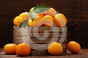 Fresh mandarin oranges fruit or tangerines in the wooden box