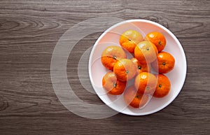 Fresh mandarin oranges fruit or tangerines on a wooden table