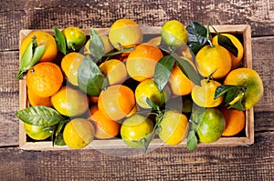 Fresh mandarin oranges fruit in wooden box