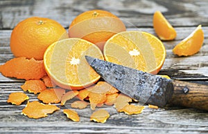 Fresh mandarins with a rustic knife