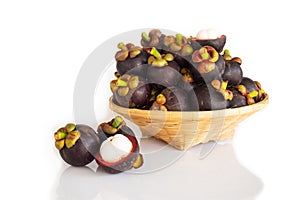 Fresh mangosteen in bamboo basket on white isolate background. Healthy and sweet fruit. High vitamins