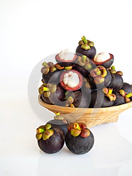 Fresh mangosteen in bamboo basket on white isolate background. Healthy and sweet fruit. High vitamins