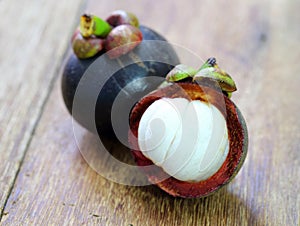 Fresh mangosteen fruit on wood