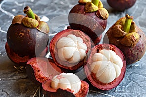 Fresh mangosteen fruits isolated on neutral background.