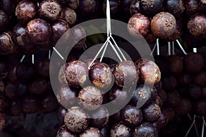 Fresh mangosteen for sale at an outdoor market, indinesian fruits