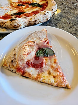 Fresh Margherita Pizza Slice on Plate, Casual Dining Background