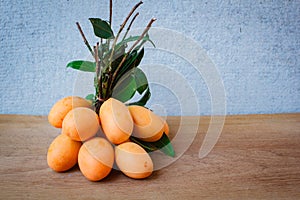 Fresh marian plum on wood background.